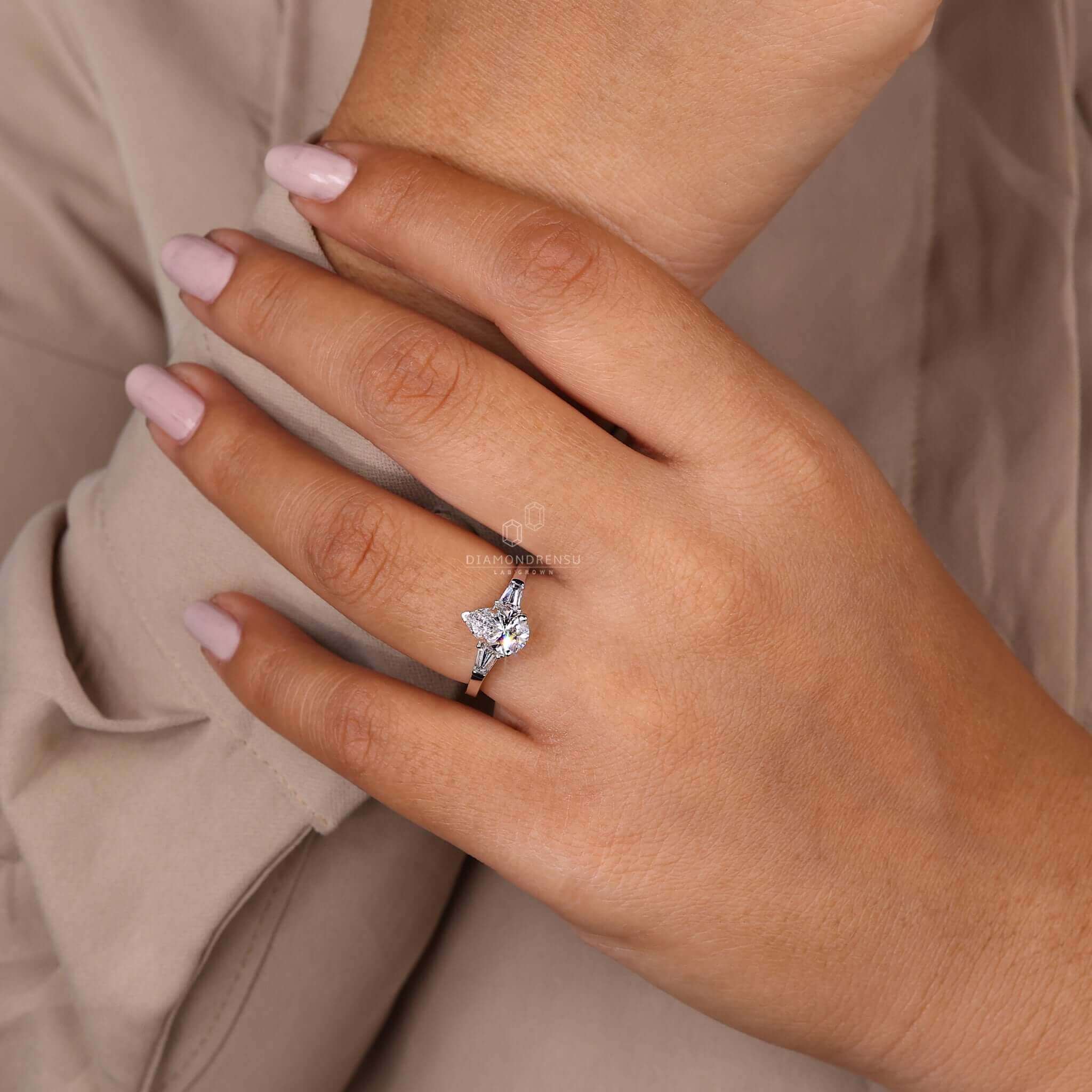 Pear and baguette diamond ring combining classic and contemporary styles.