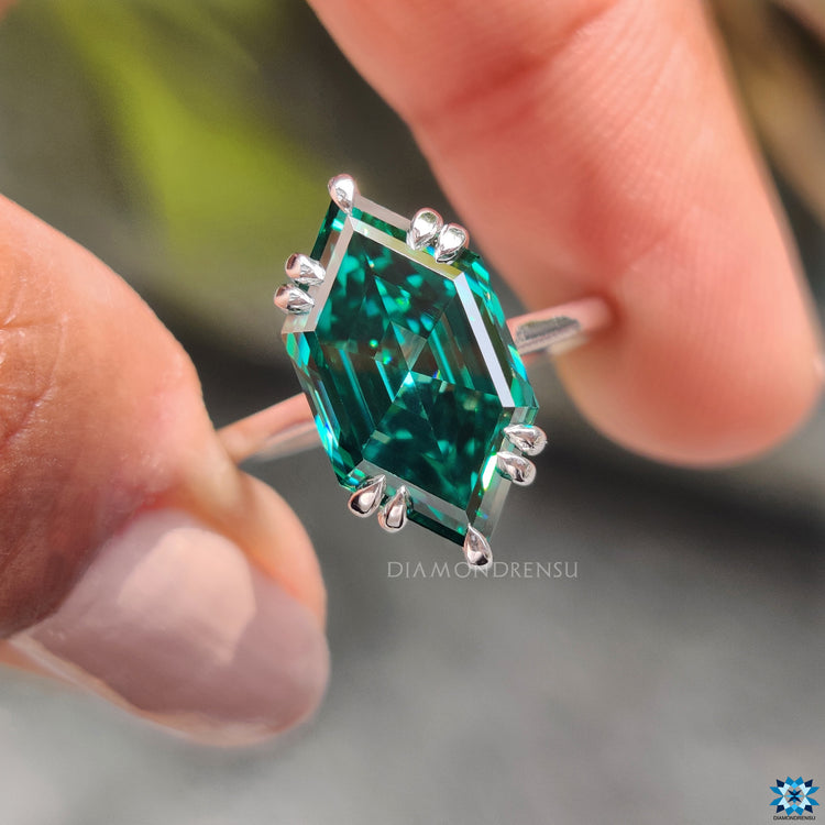 Solitaire setting ring with Dutch marquise cut moissanite in white gold.