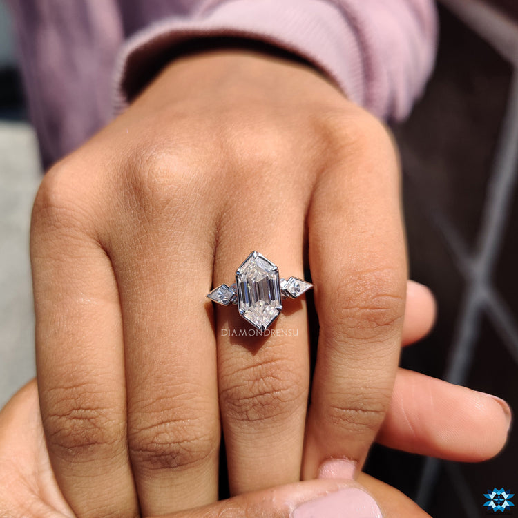 Buy engagement ring with three stone design and kite cut sides.