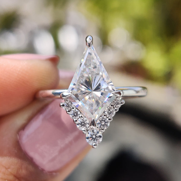 Kite cut moissanite engagement ring with secure compass prong setting.
