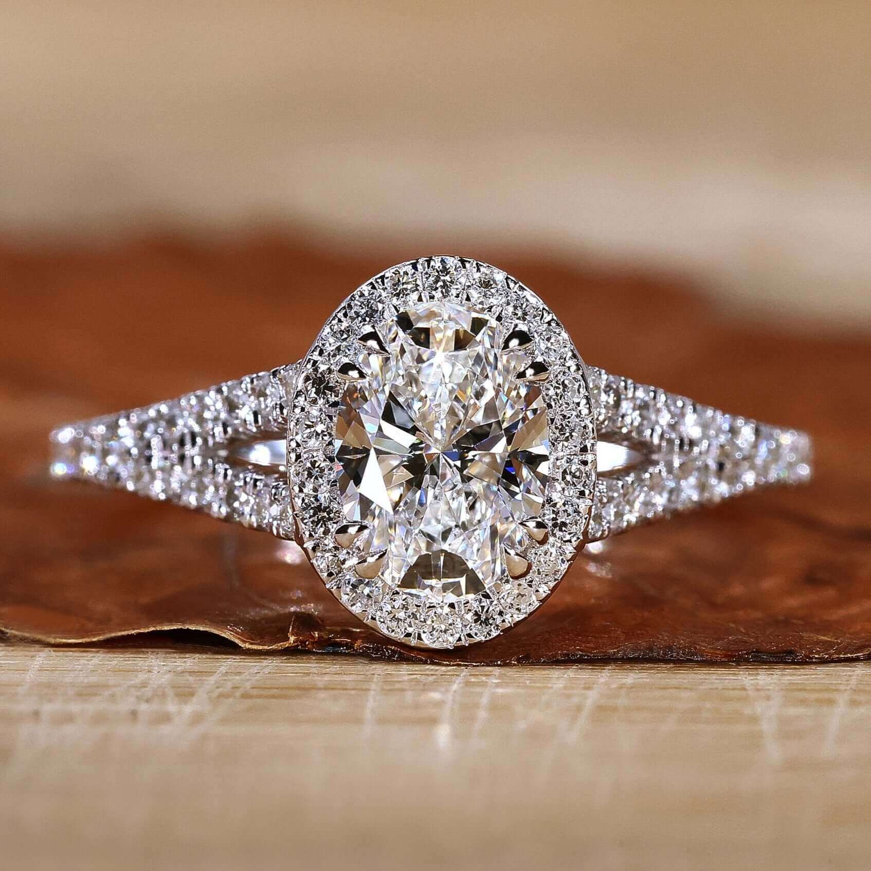 Oval diamond ring with pave setting and elegant side stones.