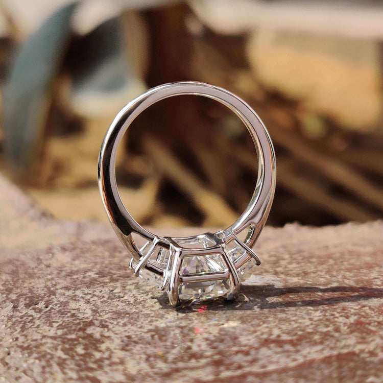 Radiant cut moissanite center stone in 4 prong claw setting.