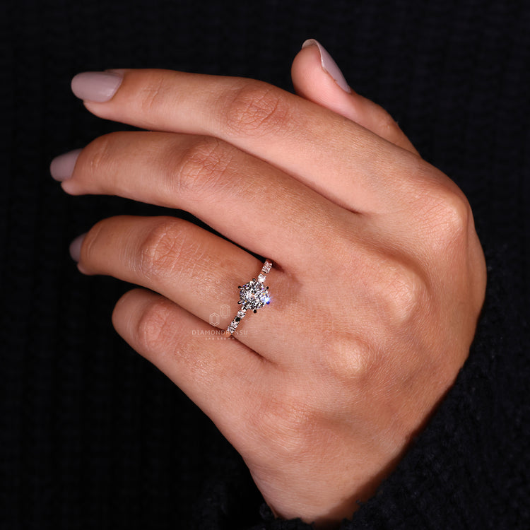 Round cut side stone ring crafted as a handmade engagement ring.