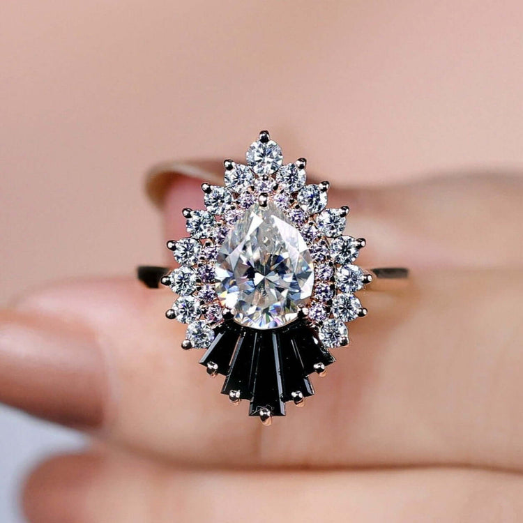 Snowflake halo engagement ring with pear cut moissanite.