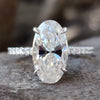 Moval cut moissanite engagement ring in white gold.
