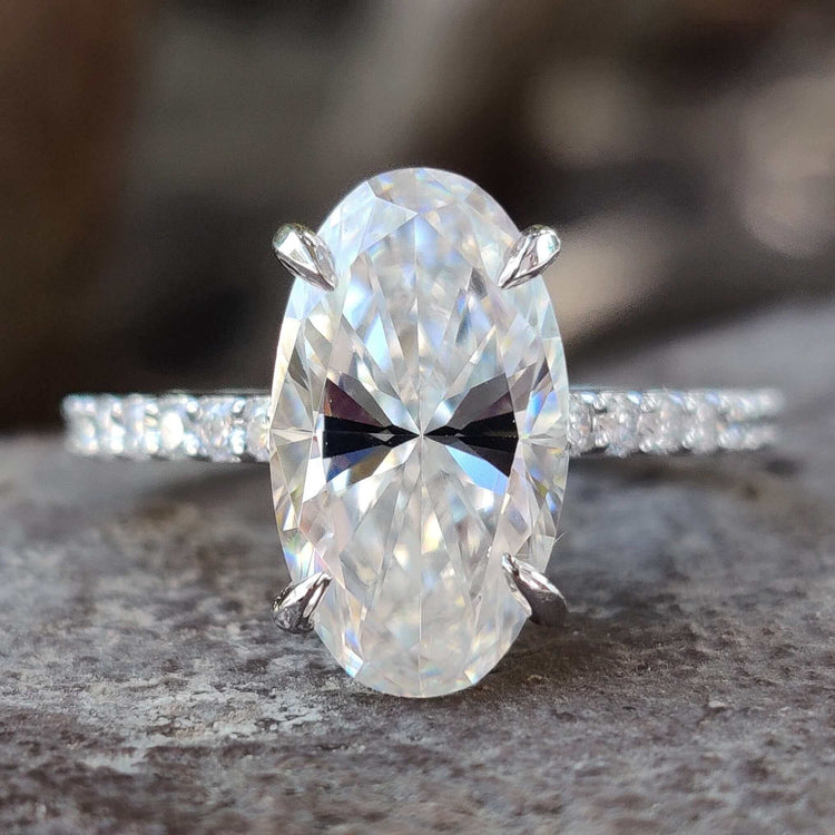 Moval cut moissanite engagement ring in white gold.