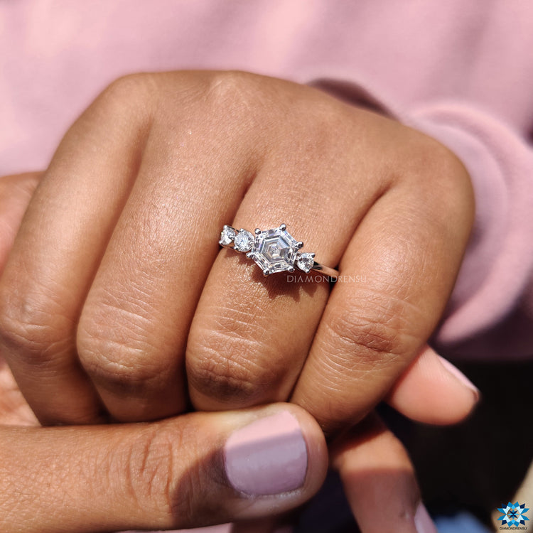 Four-stone moissanite engagement ring in white gold with handmade finish.