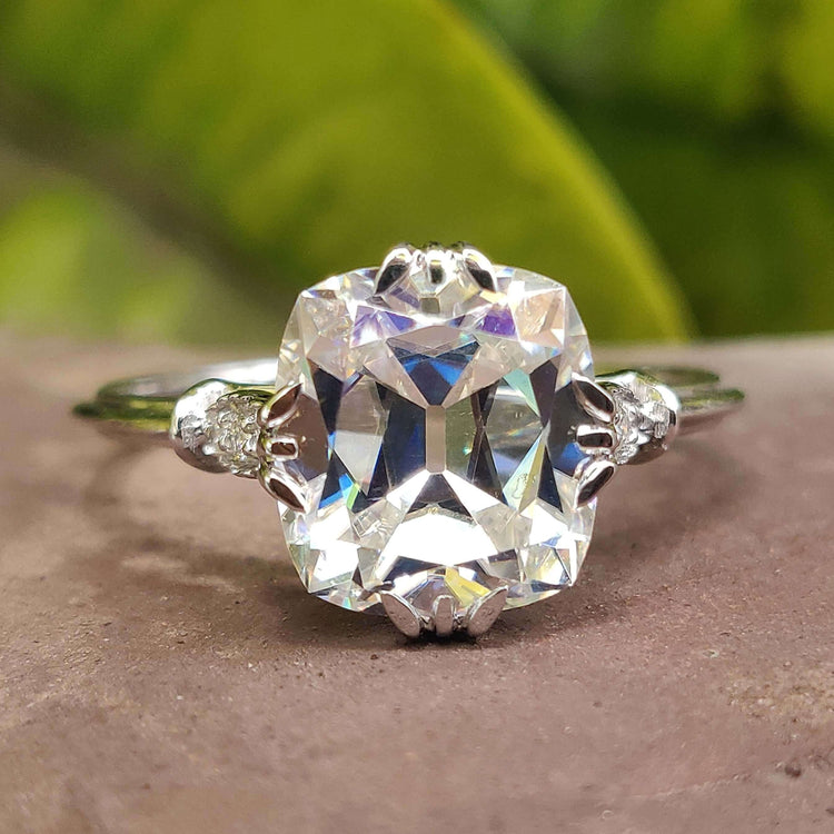 Cushion cut moissanite engagement ring in white gold.