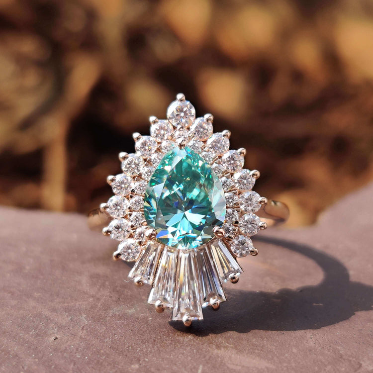 Vintage pear cut engagement ring with cyan blue moissanite.