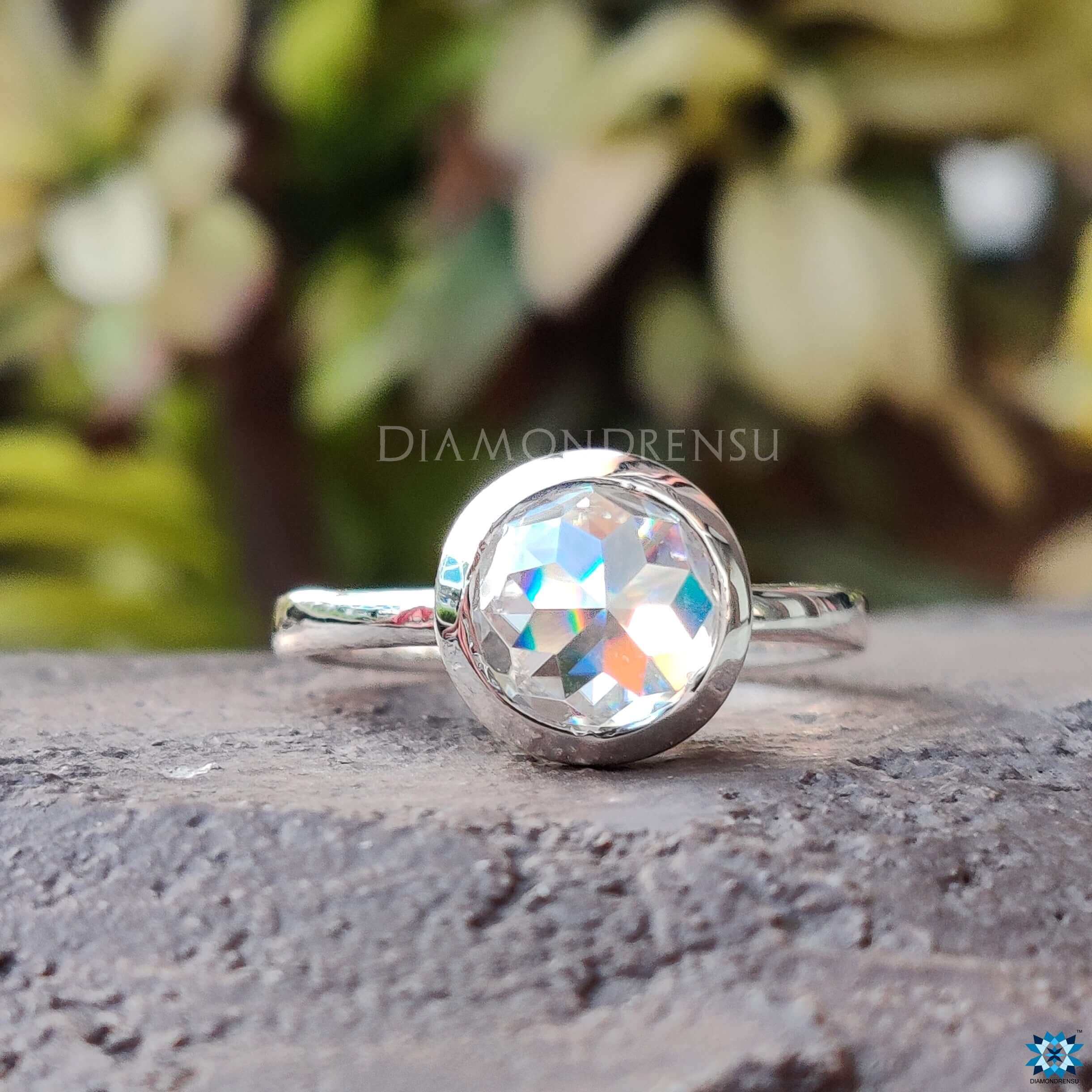 Diamondrensu UK engagement ring with round rose cut Moissanite and bezel mount.