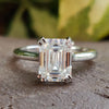 Emerald cut moissanite engagement ring in white gold.