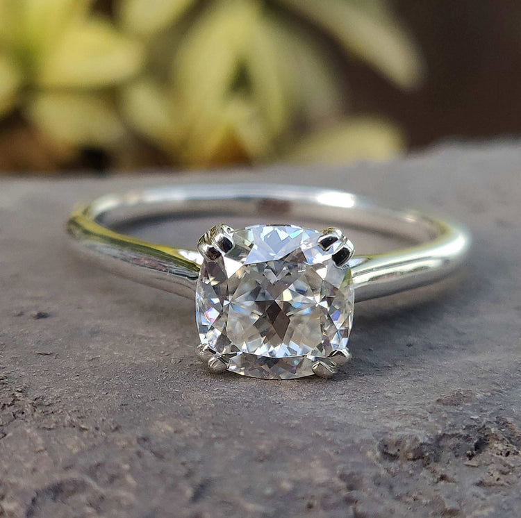 Cushion cut ring in cathedral setting with double prong setting