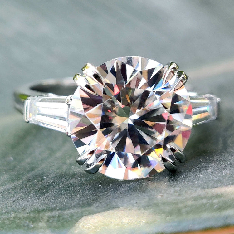 Three stone moissanite engagement ring in white gold.