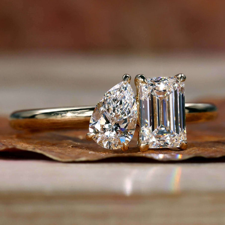 Two Stone Engagement Ring with pear and emerald cut diamonds in a prong claw setting, perfect for a unique design.