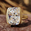 Half bezel engagement ring with elongated cushion cut moissanite.
