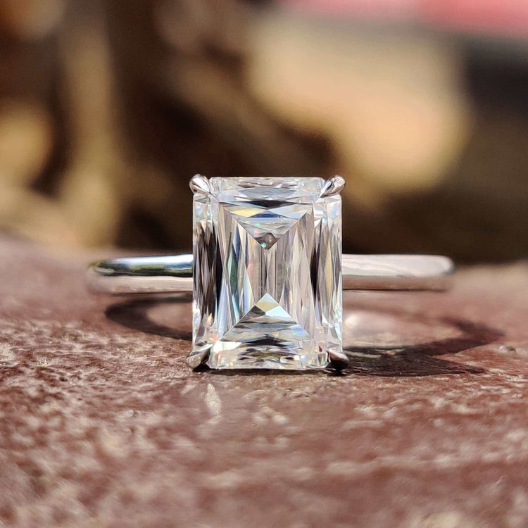 Criss cut solitaire engagement ring in white gold with claw prongs.