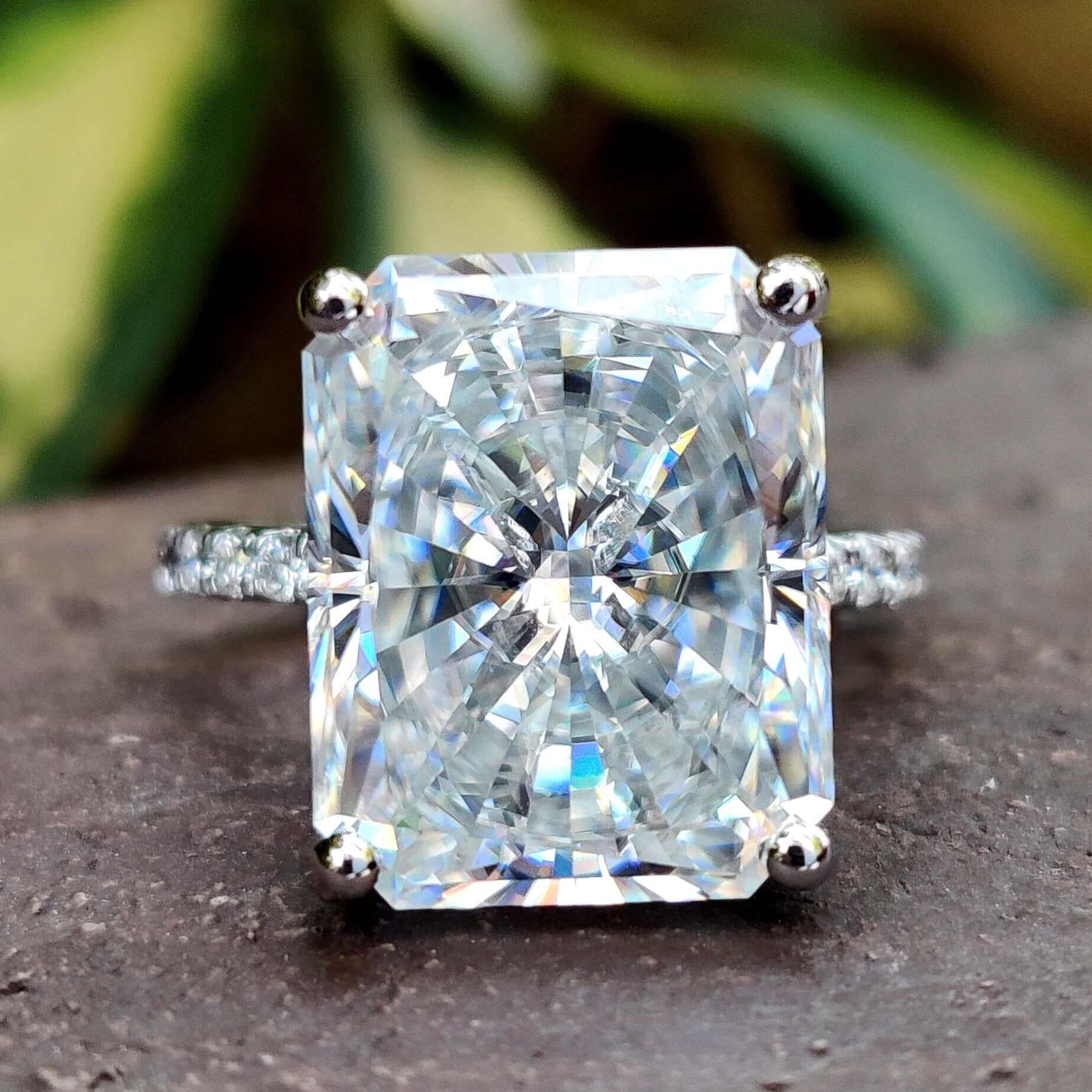 Elongated radiant cut moissanite ring in white gold.