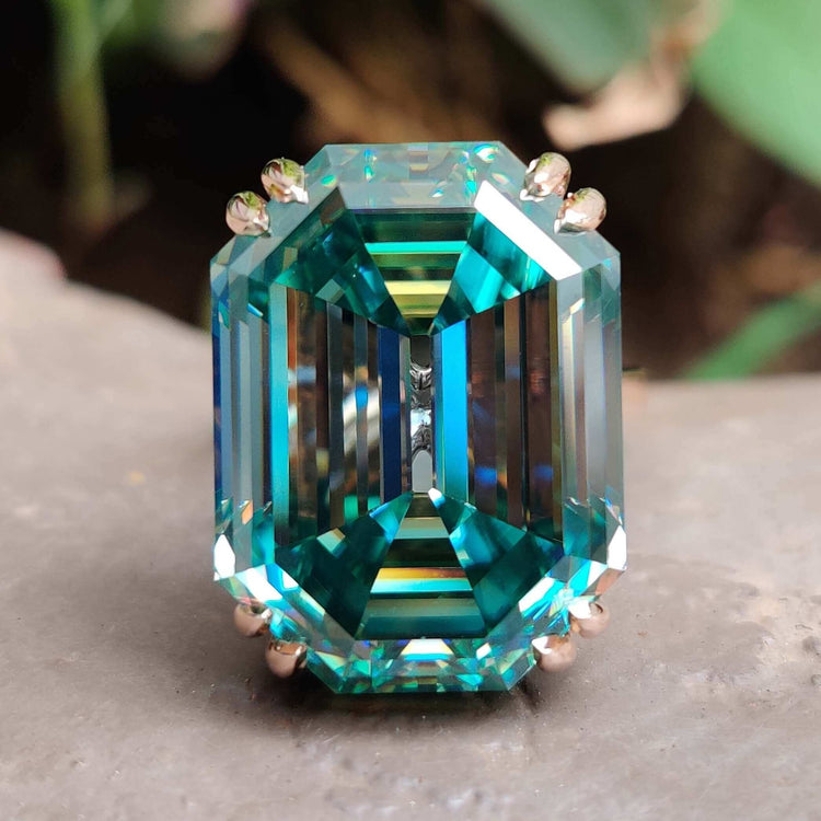 Rose gold ring with cyan blue moissanite center stone.