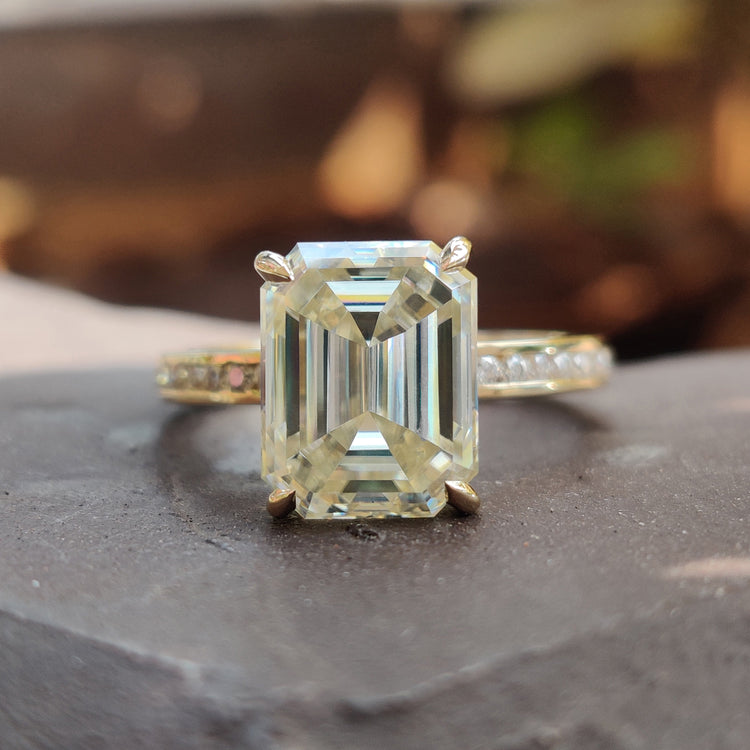 Hidden halo engagement ring with emerald cut light yellow moissanite centre.
