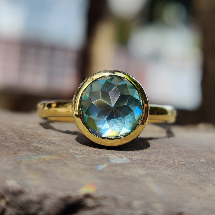 Rose cut engagement ring with aqua blue green moissanite in bezel.