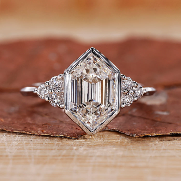 Engagement ring with bezel setting and hexagon step cut diamond.