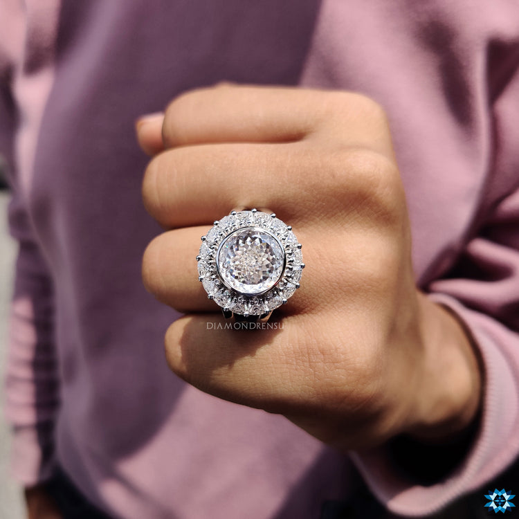 Portuguese cut moissanite centre with bezel halo and split shank.