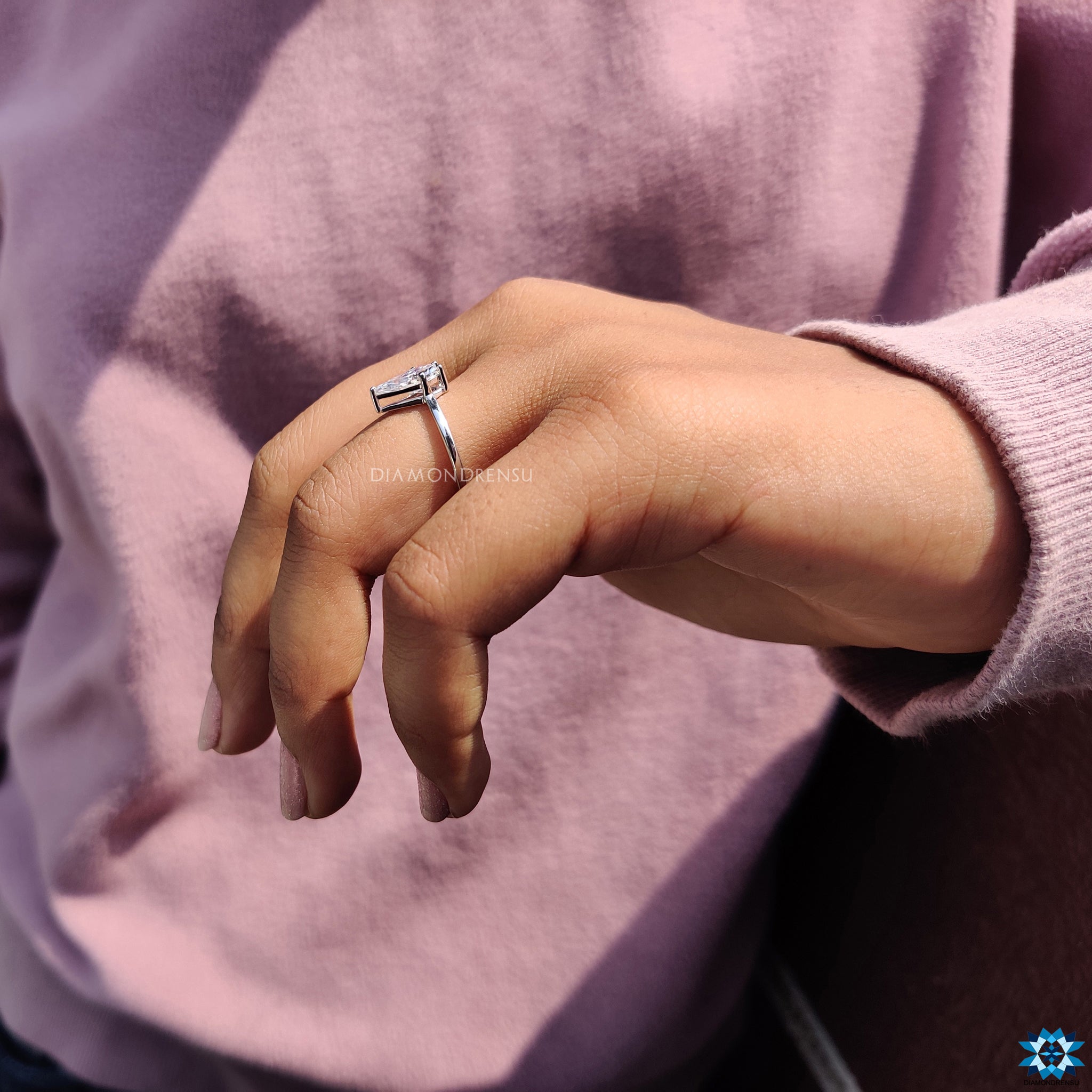 Custom engagement ring with spear cut stone and white gold finish.
