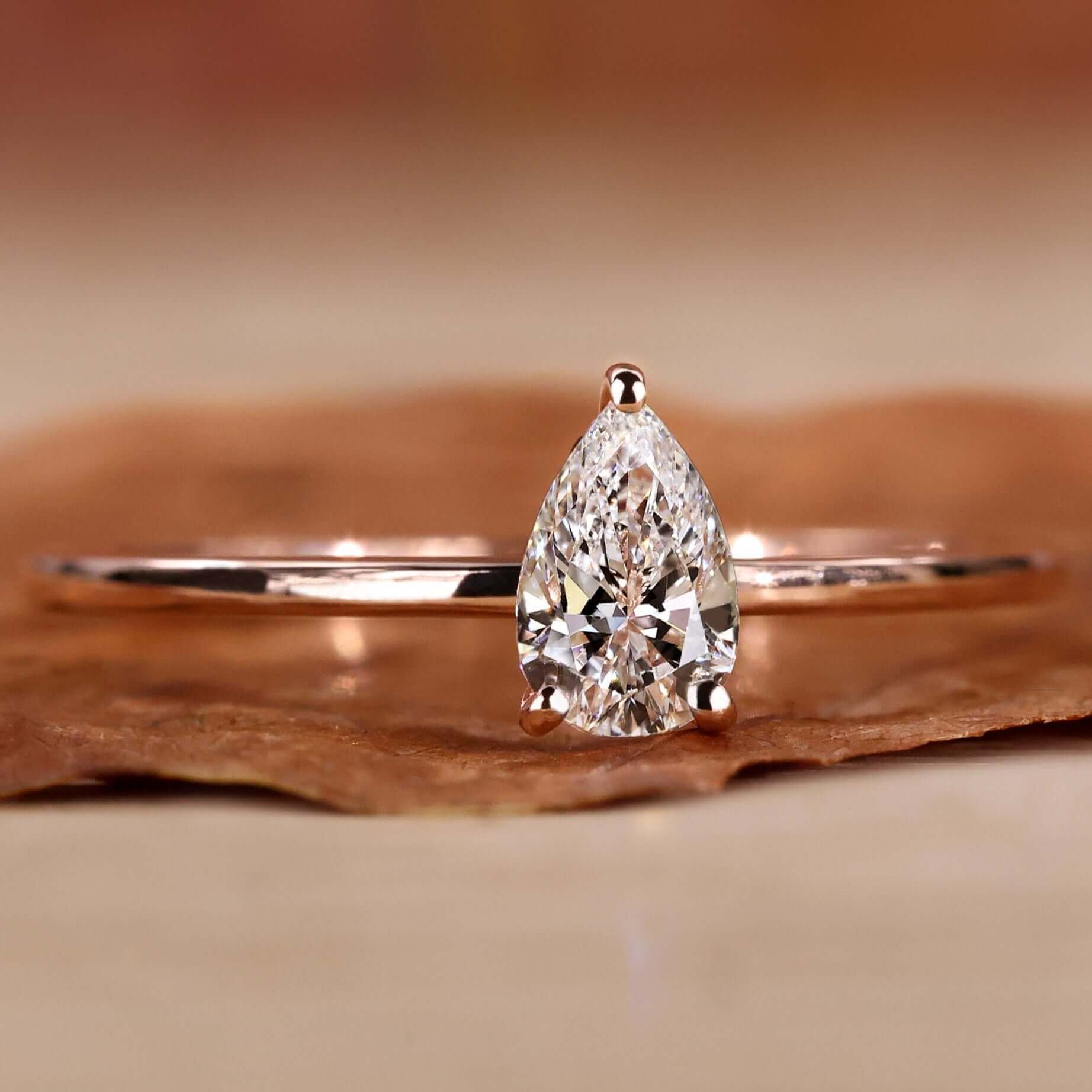 Pear solitaire engagement ring with a stunning handmade design.