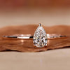 Pear solitaire engagement ring with a stunning handmade design.