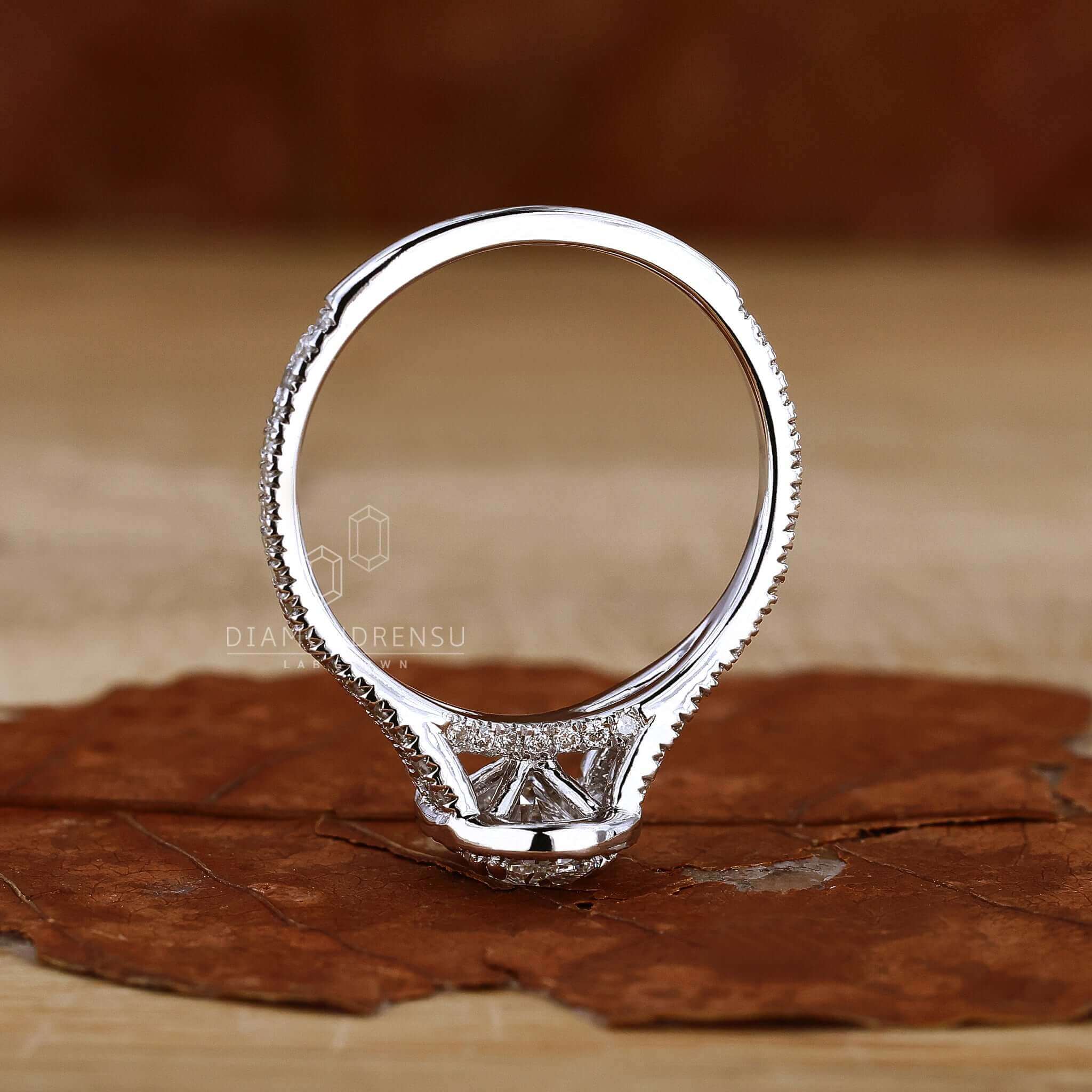Gold oval engagement ring with halo diamond detailing.