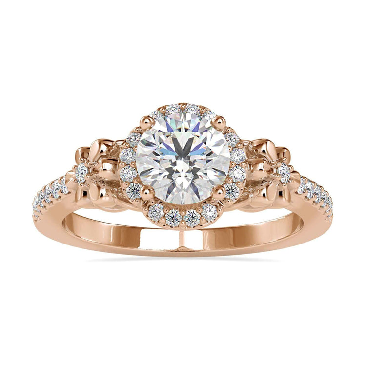 Flower diamond engagement ring with round cut centre and pave band.