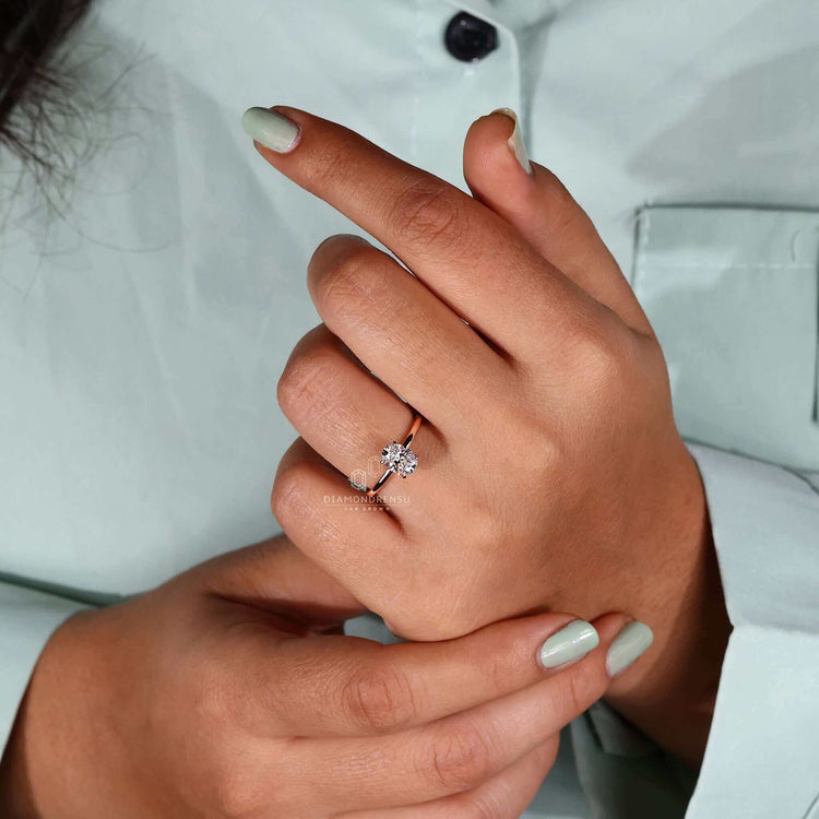 Oval cut diamond ring with claw prong ring setting detail.