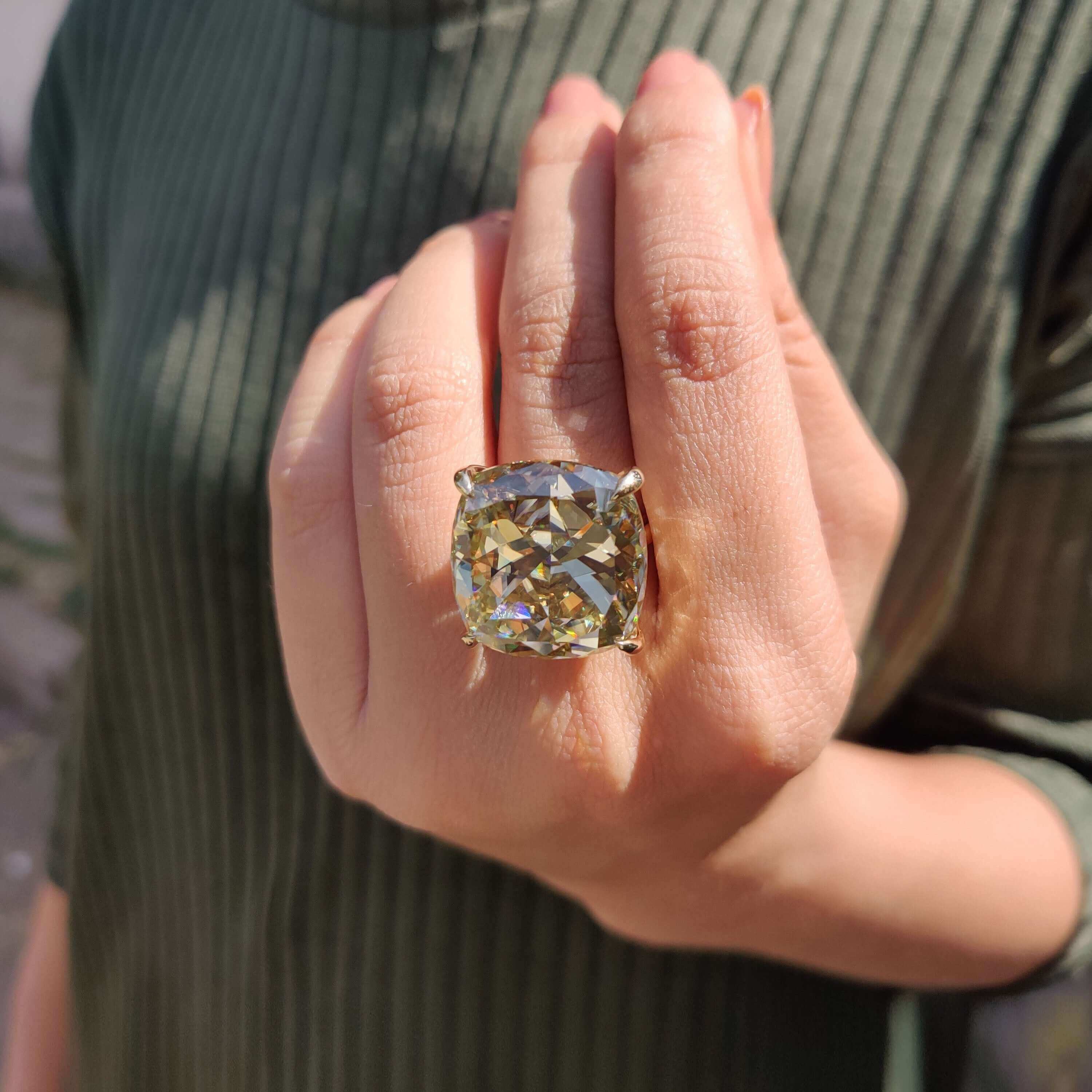 Prong set cushion moissanite ring in gold.
