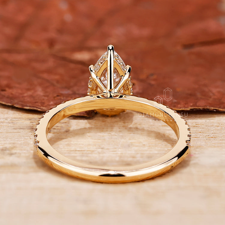 Handmade ring with pave setting and pear cut diamond details.