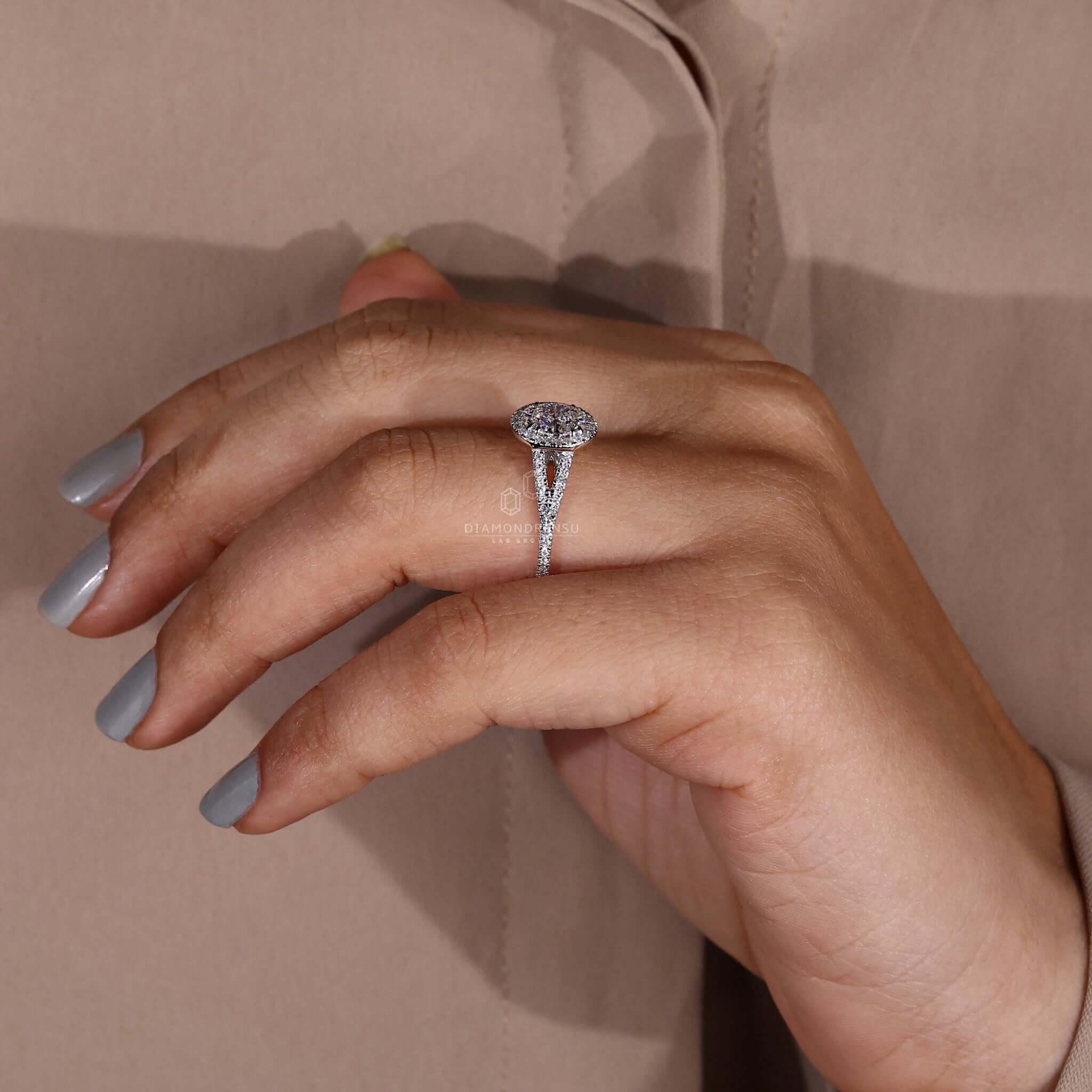 Halo ring with pave diamond detailing and claw prong setting.