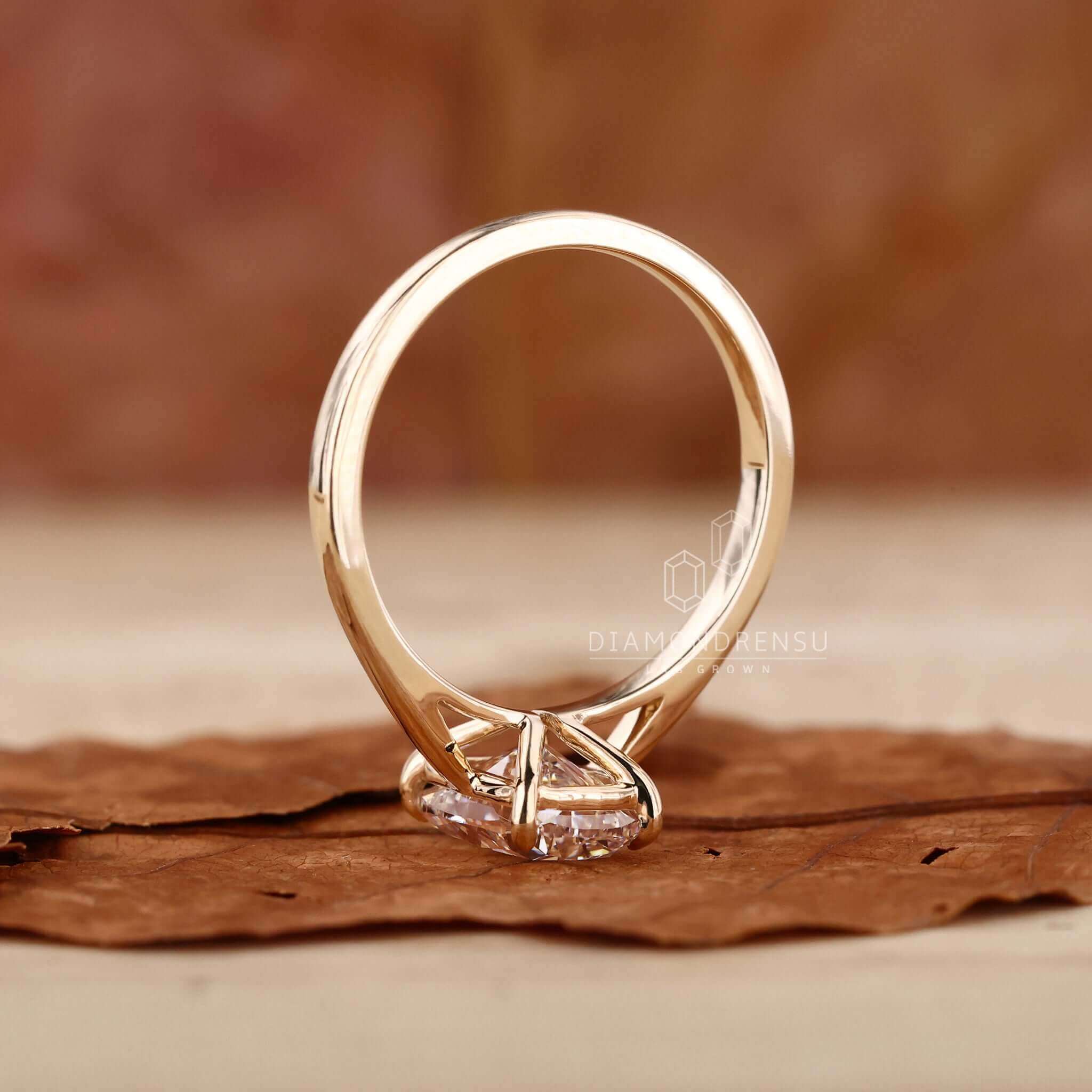 Solitaire ring with an elongated cushion cut diamond in a claw prong design.