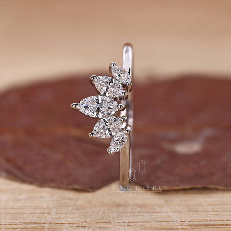 Prong set diamond band with marquise stones in a custom design.