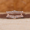 Double curved wedding band in rose gold finish.