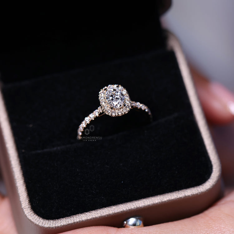Round cut pave setting with halo diamond design.