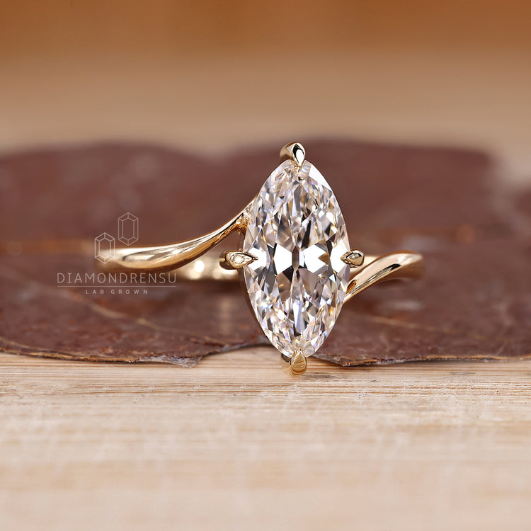 Marquise old european cut diamond ring with compass prong setting design.