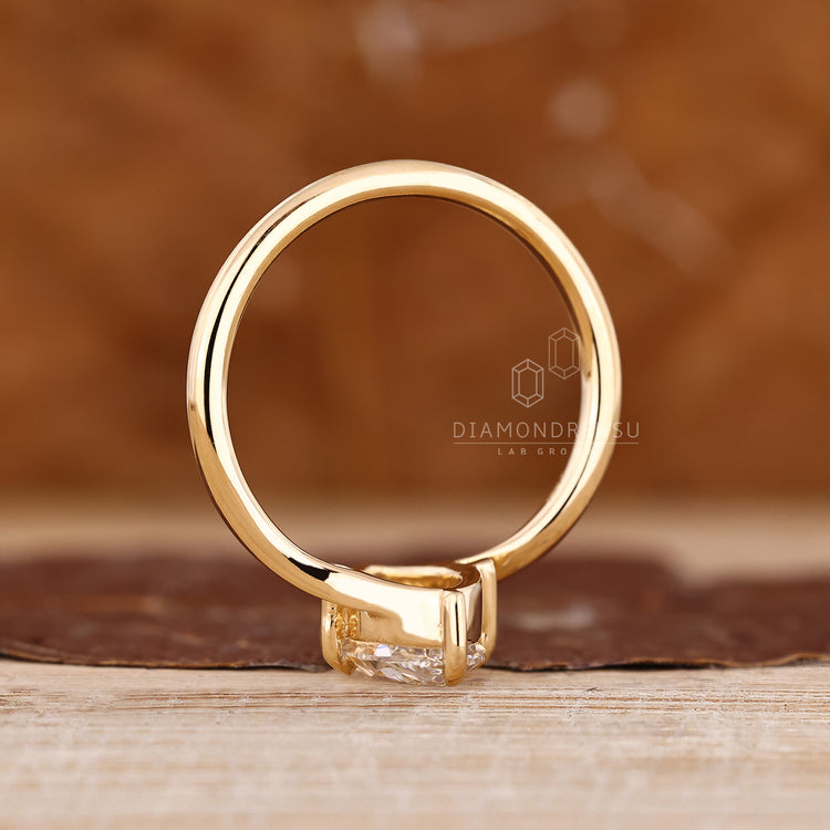 Solitaire engagement ring with bypass setting and marquise old european diamond.