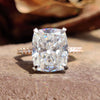 Elongated cushion cut moissanite ring with pave band.