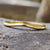 Sleek curved wedding band in yellow gold, perfect for timeless elegance. Sleek curved wedding band in yellow gold, perfect for timeless elegance.