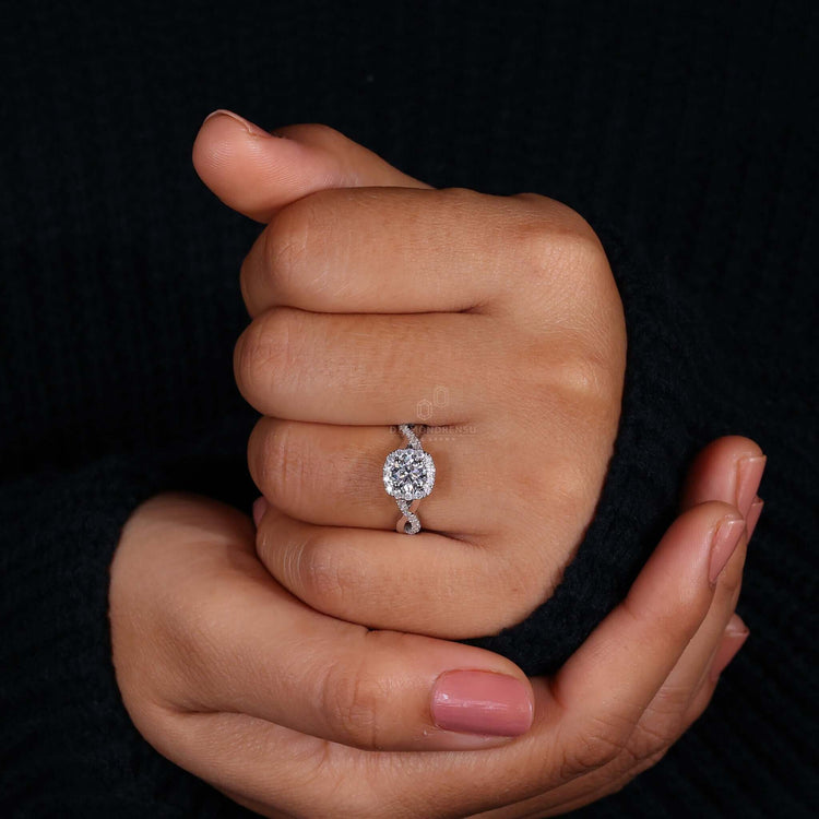 Silver twist ring featuring a round diamond and pave setting, perfect as a unique engagement ring.