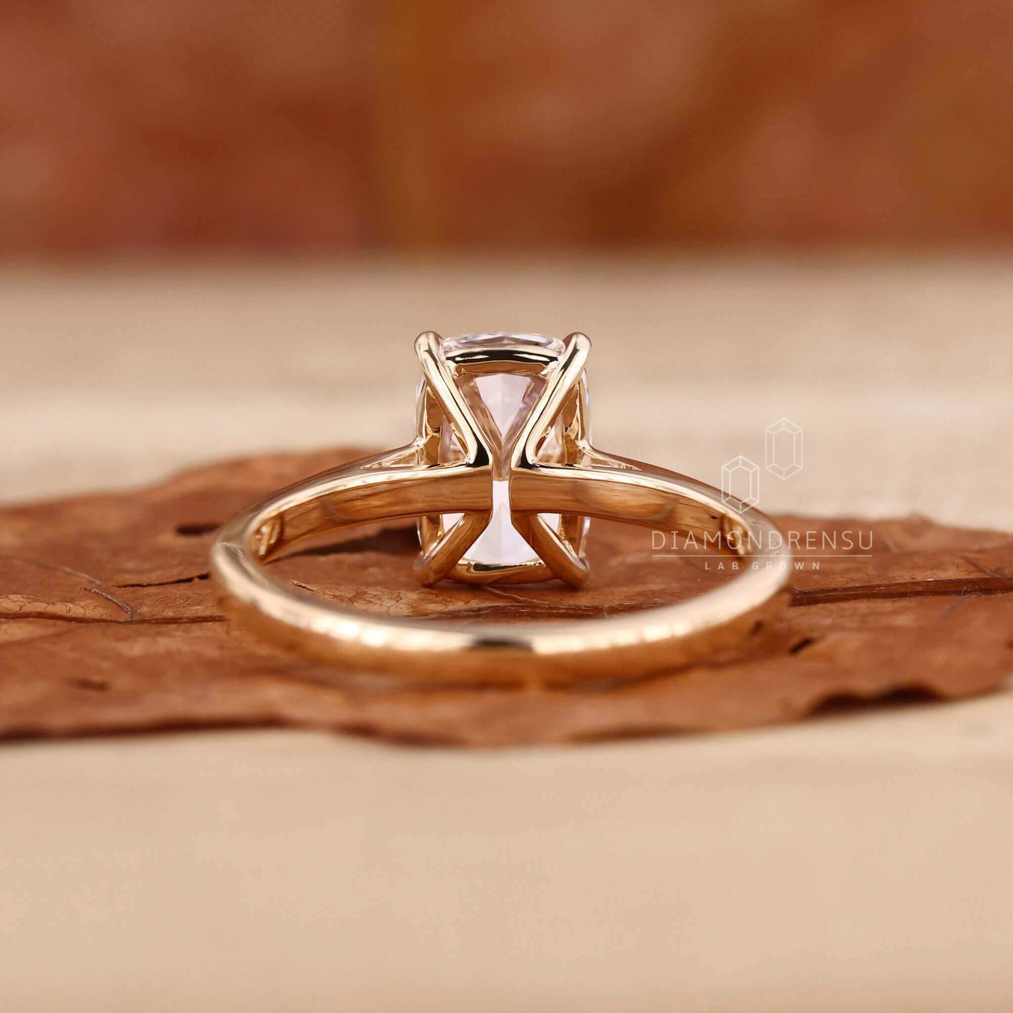 Diamond solitaire ring featuring a handmade elongated cushion cut design.