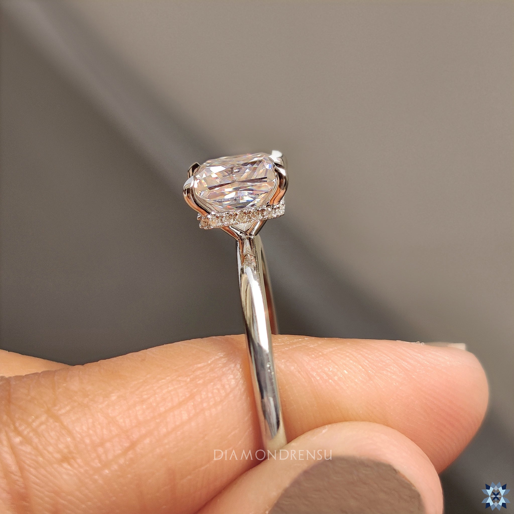 White gold ring in hidden halo engagement ring setting
