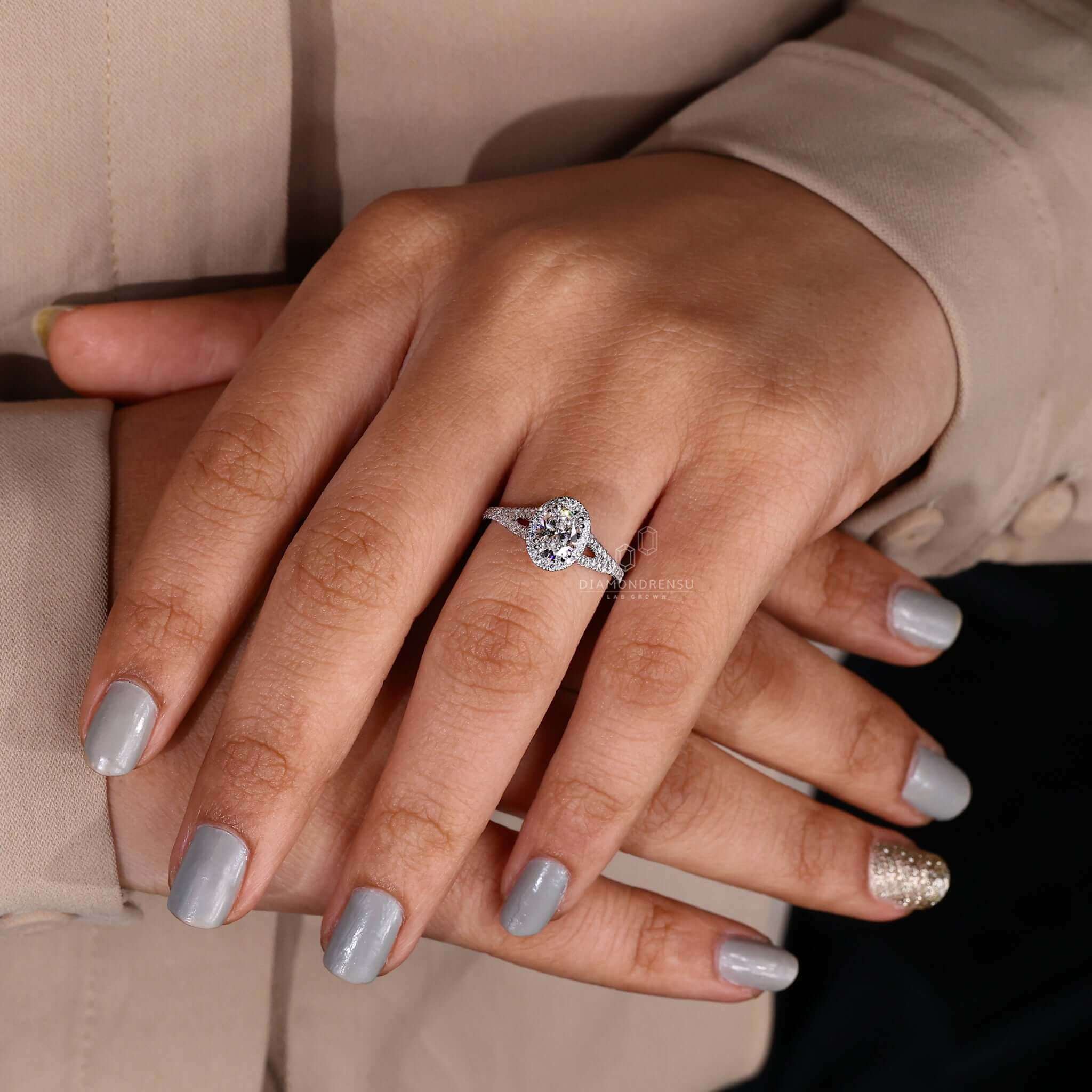 Halo diamond ring with split shank and cathedral setting.