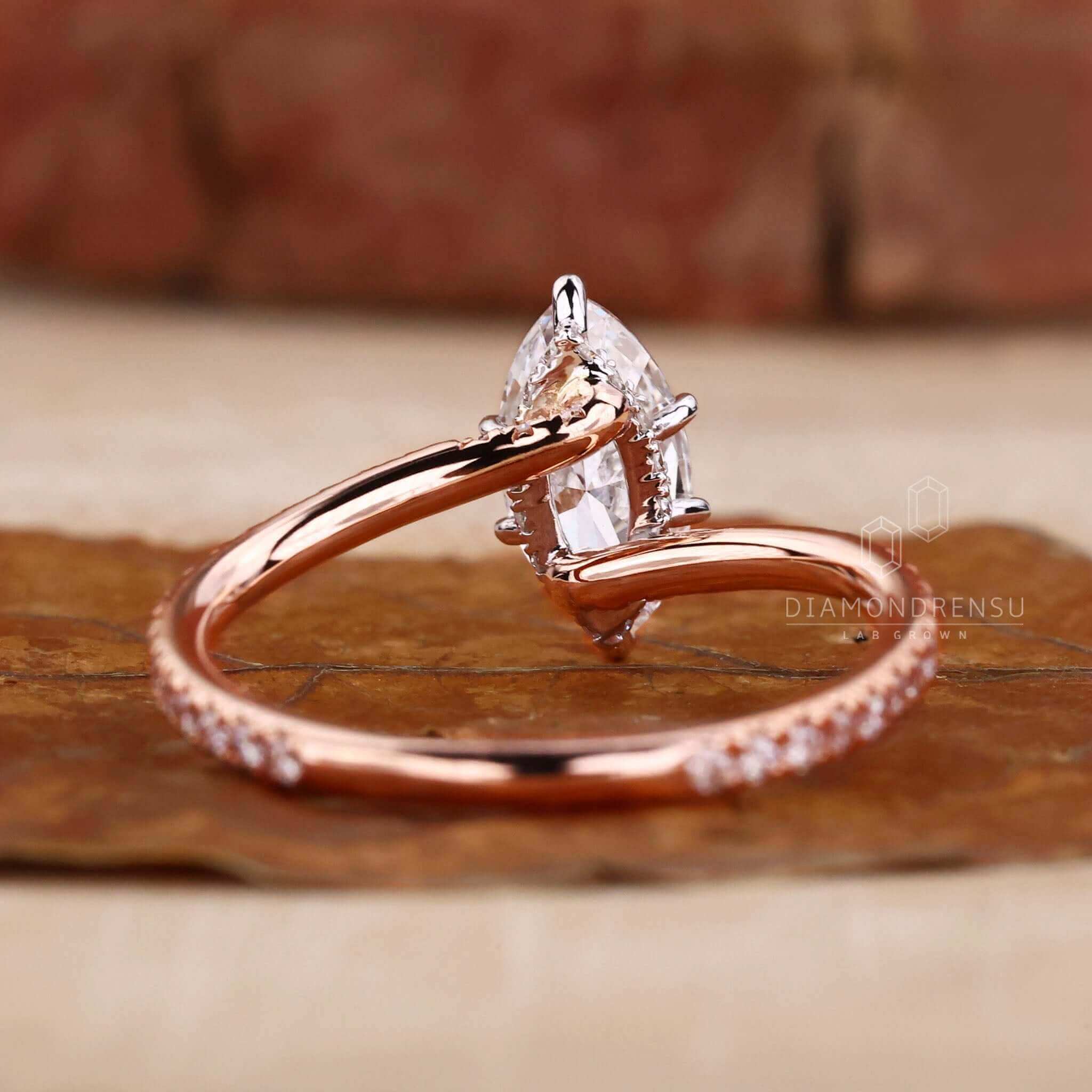 Pave diamond ring with a marquise cut diamond, handcrafted for women seeking unique engagement ring designs.