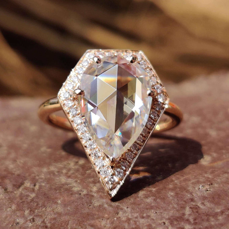 Pear cut moissanite ring in rose gold setting.