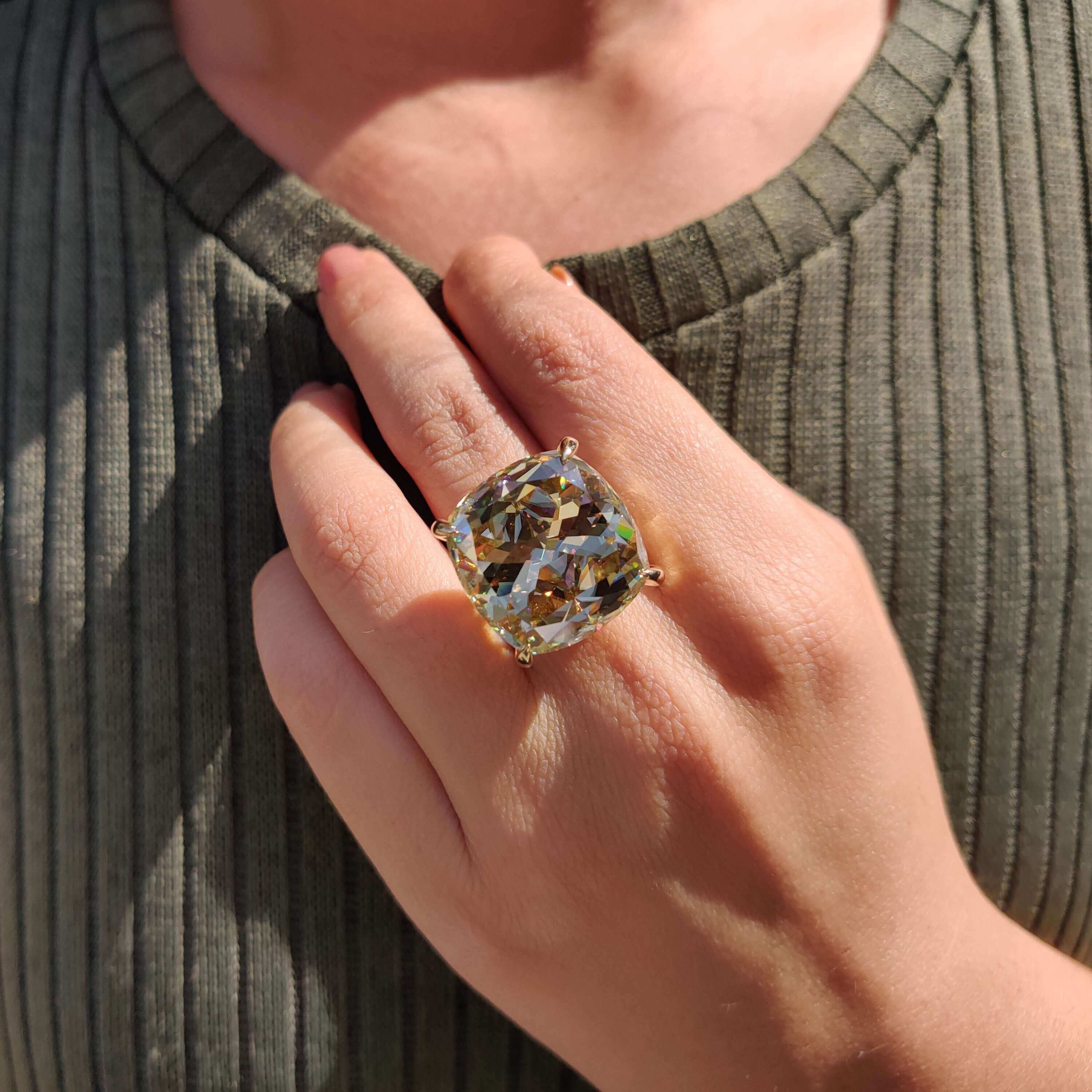 Yellow gold solitaire engagement ring with cushion cut.